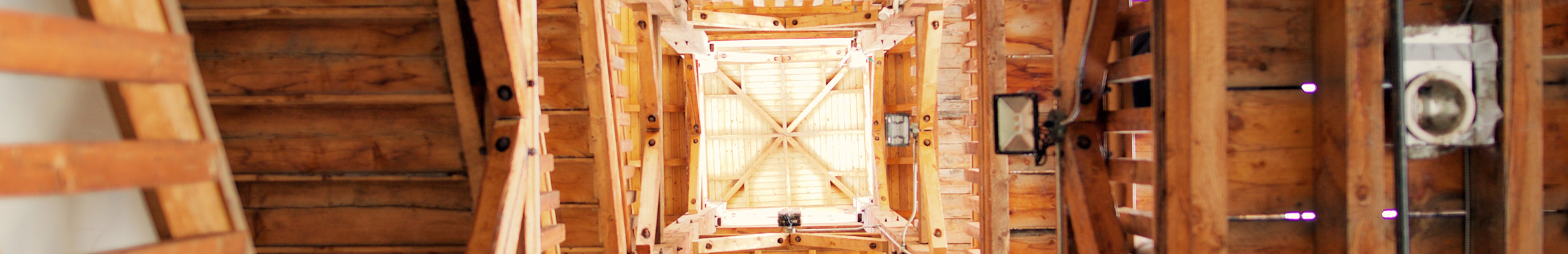 A wide angle shot, showing the tall, wooden architecture of the Hillside Winery and Bistro ceiling. 