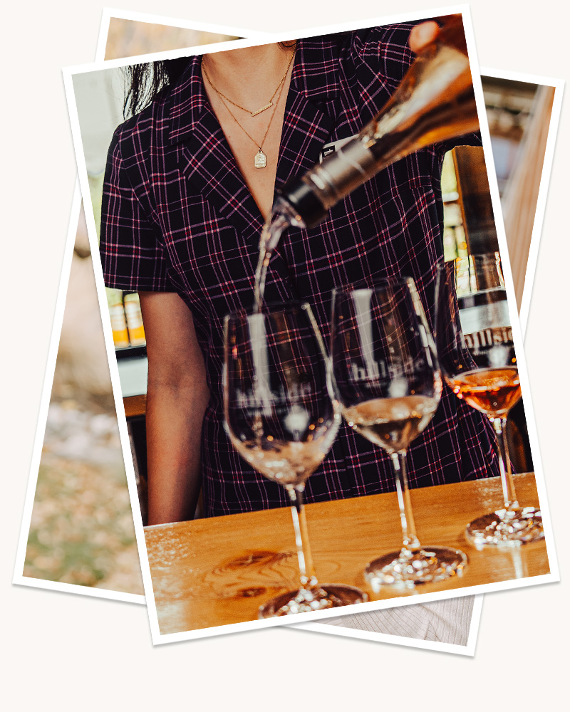 Two digitally stacked images, the top, and visible, image showing a Hillside Winery employee pouring wine into Hillside Winery labelled glasses on a wood table. 