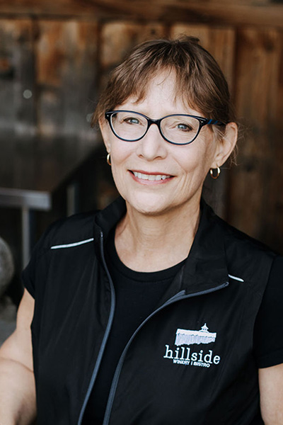 A smiling profile of Winemaker, Kathy Malone. 